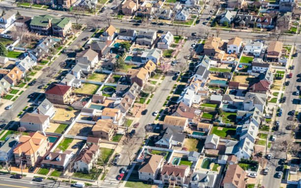 An aerial view of detached houses on suburban streets